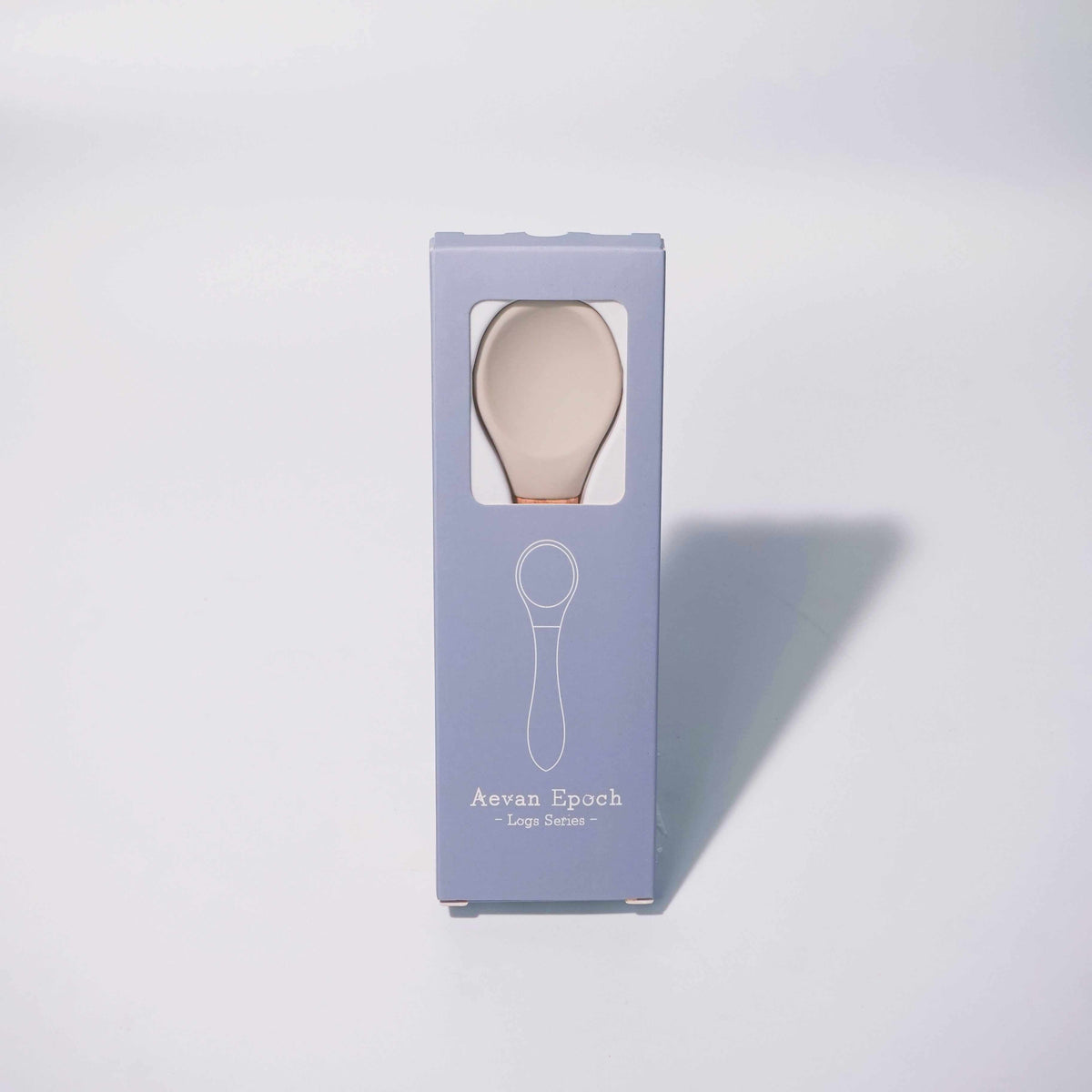 Beechwood Silicone Spoon in pale blush silicone with a natural wood handle, displayed in a lavender box with a spoon outline.