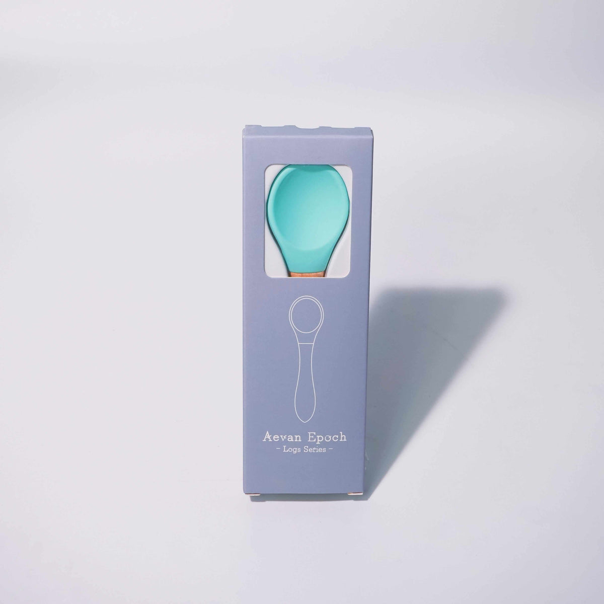Beechwood Silicone Spoon with a turquoise silicone head and visible tan wooden handle, displayed in a lavender box