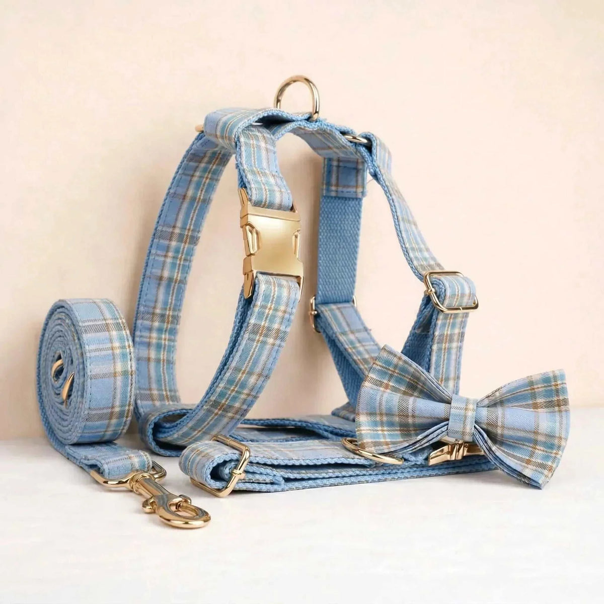 personalized no pull dog harness set in light blue plaid nylon, with matching leash, collar, bow tie and gold-tone hardware
